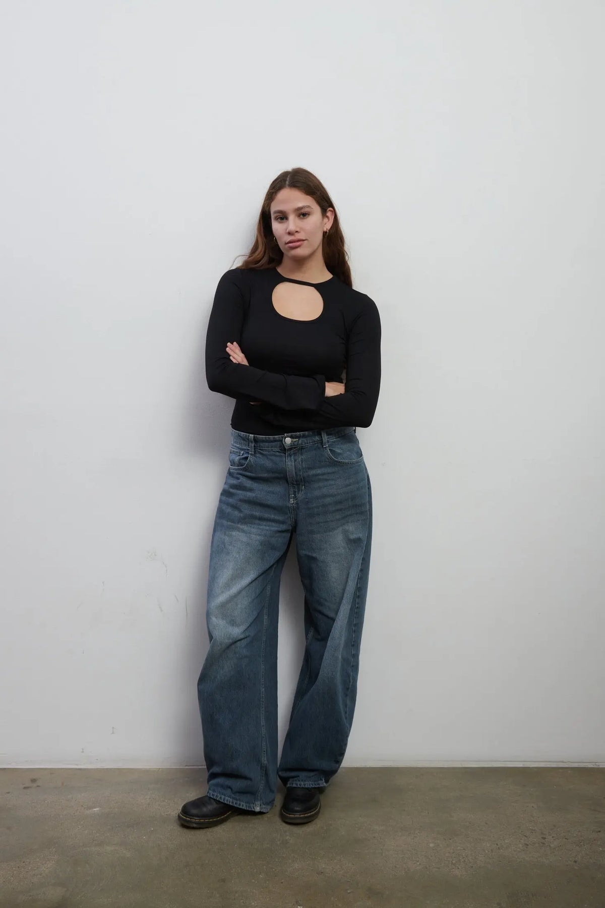Model wearing an everyday soft long sleeves black top with a rounded cut-out. The top is made with Tencel™Modal fabric.