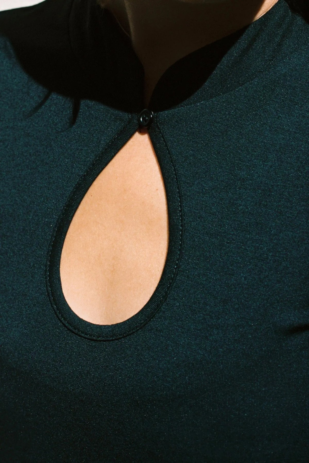 Black Meghane Top keyhole cutout button detail closeup