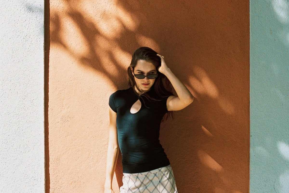 Woman wearing black Tencel Modal short sleeves top with a keyhole cutout